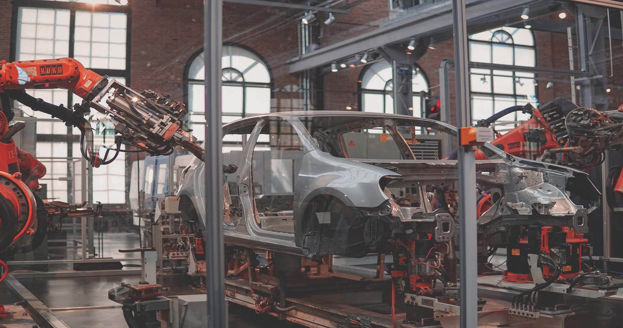 robots building a car - an example of AI use cases in manufacturing