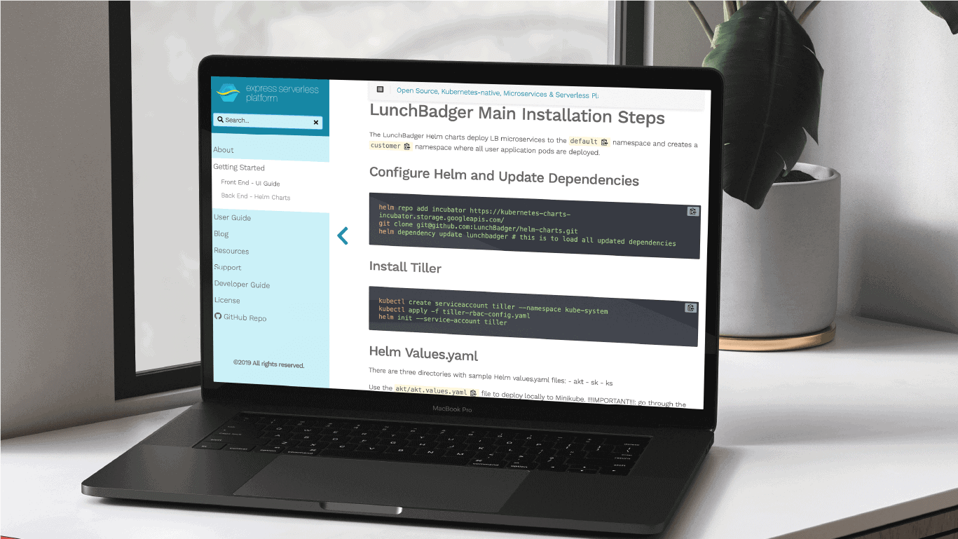 Laptop displaying a technical document with installation steps and code snippets for LunchBadger.