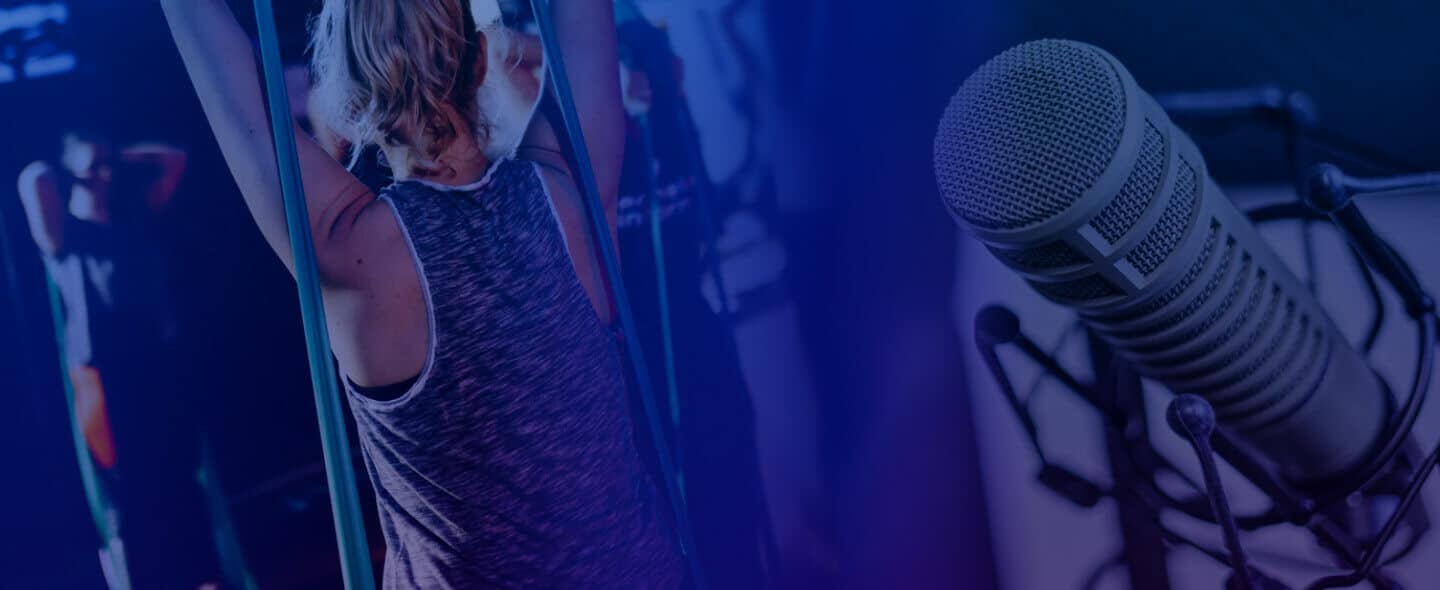 Fitness class scene blended with a studio microphone, symbolizing online workouts, live coaching, and fitness podcast or streaming content.