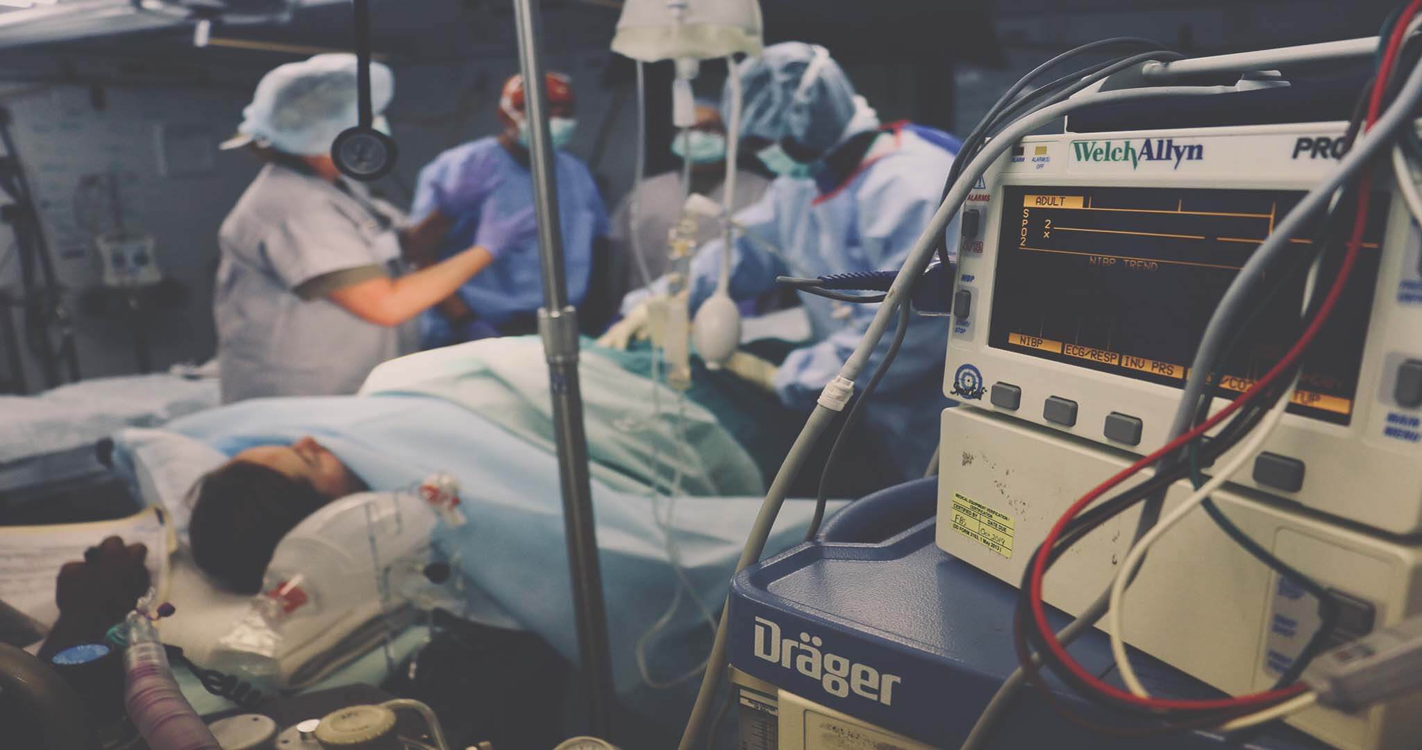 hero image: a medical operation, doctors using technology in the healthcare industry