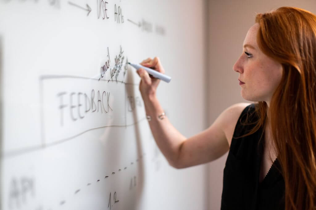 redhead woman handling responsibilities of a product owner proxy