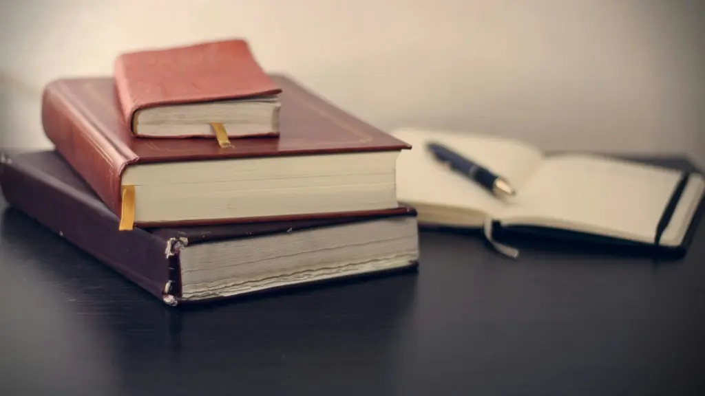 AI Act compliance research with legal books, a notebook, and a pen on a desk