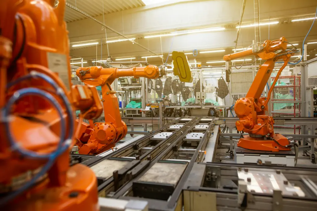 Industrial robotic arms on an automated production line using generative AI in manufacturing
